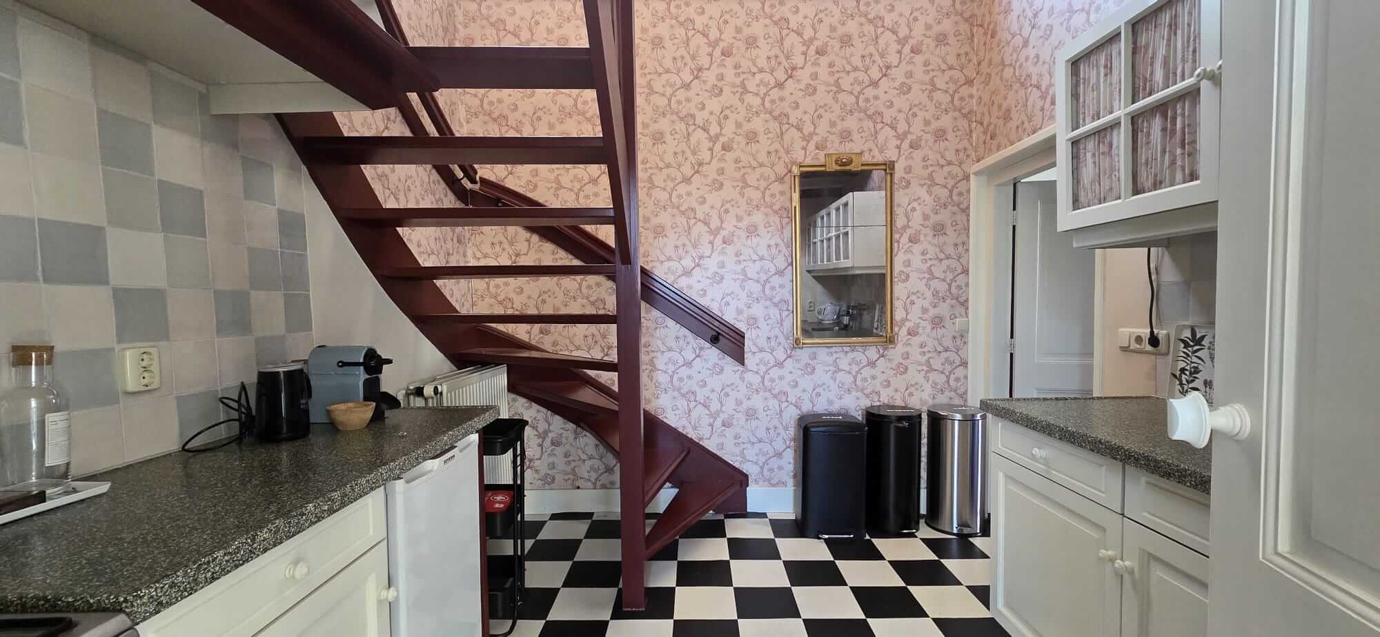 Hal met authentieke houten trap en klassieke tegelvloer